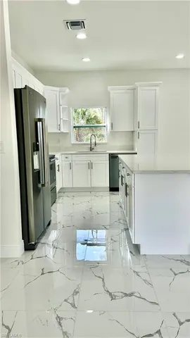 a kitchen with a stove a refrigerator and a sink