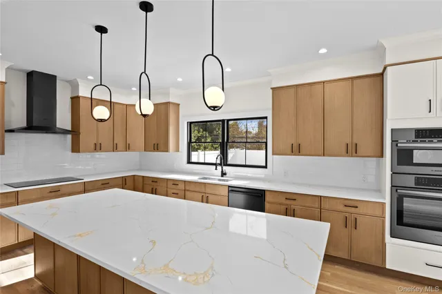 a kitchen with stainless steel appliances granite countertop a sink a stove and a wooden floors