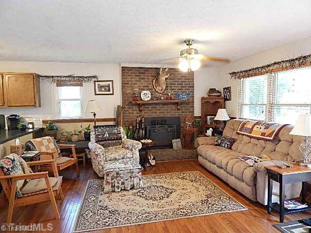 4036 Flat Shoals Road Germanton, NC 27019 - Photo 2 of 16 Living Room. Spacious living room with masonry fireplace and wood flooring.