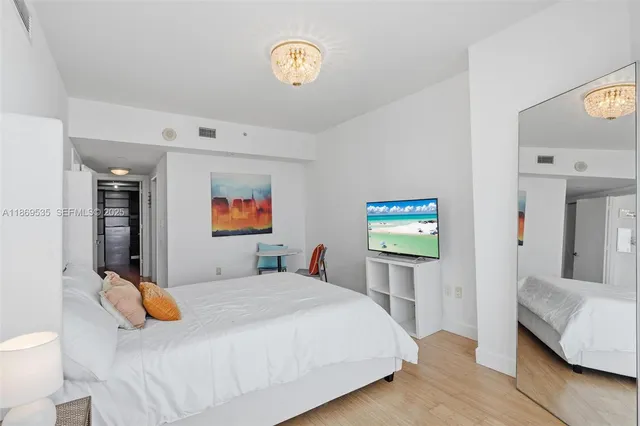 a spacious bathroom with a toilet a sink and mirror