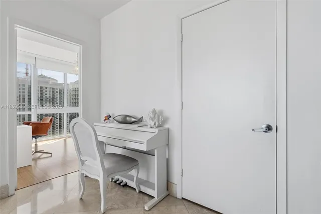a view of a livingroom with furniture and a floor to ceiling window
