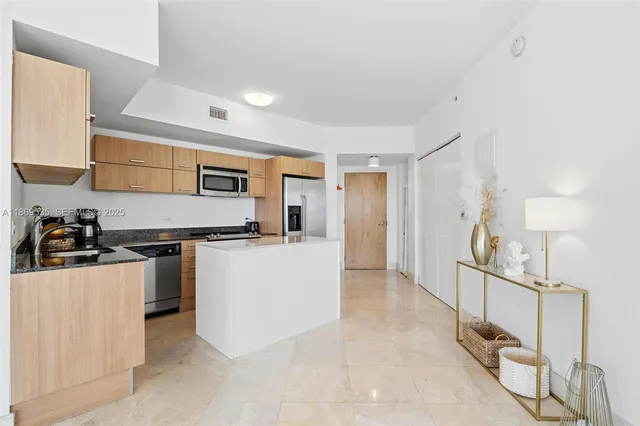 a kitchen with sink cabinets and stainless steel appliances