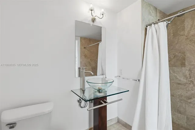 a roof deck with a table and chairs and wooden floor