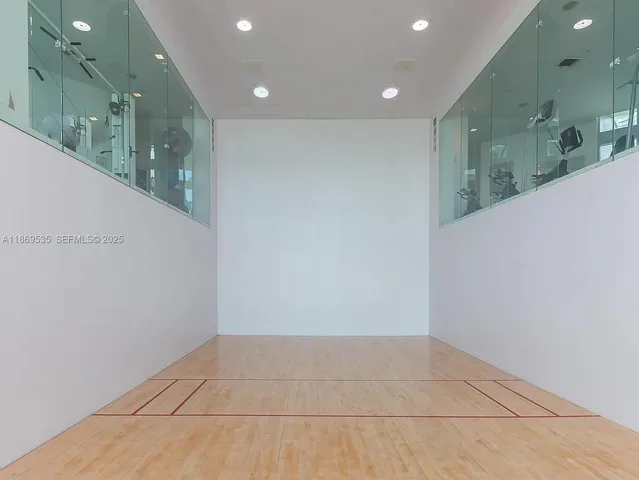 a view of a swimming pool with chairs in a patio