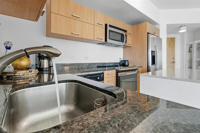 a view of kitchen and sink with living room
