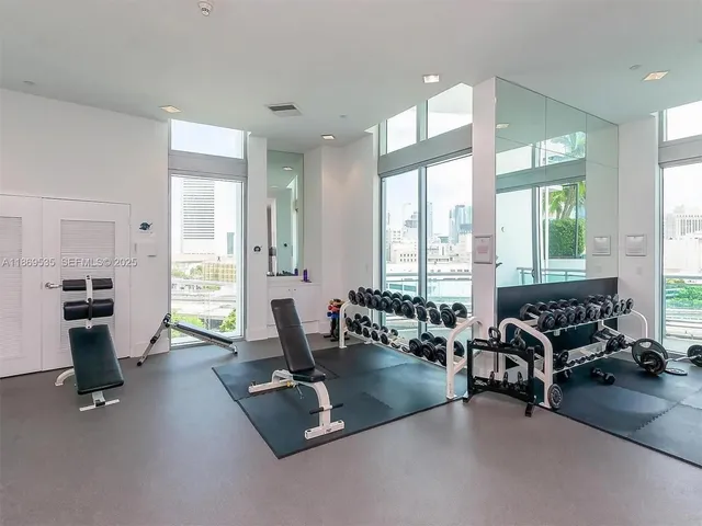 a lobby with furniture and floor to ceiling window