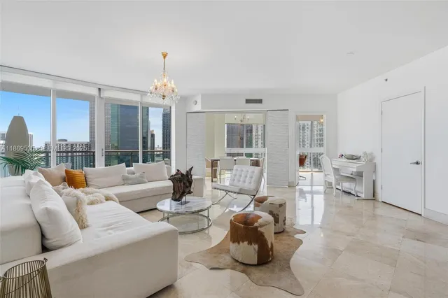 a living room with furniture and a chandelier