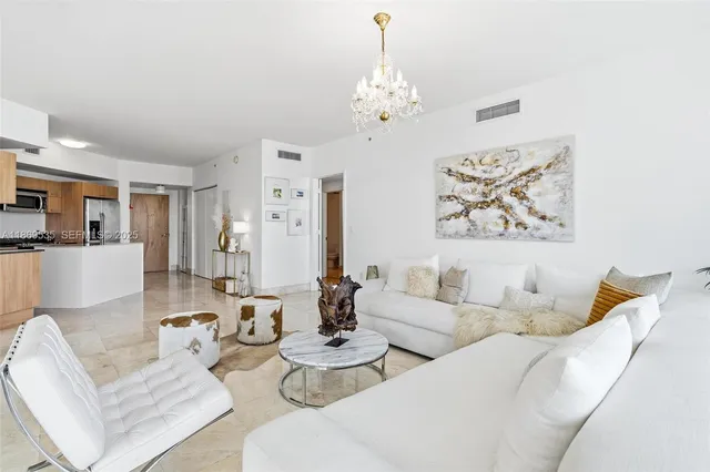 a dining room with furniture and a chandelier