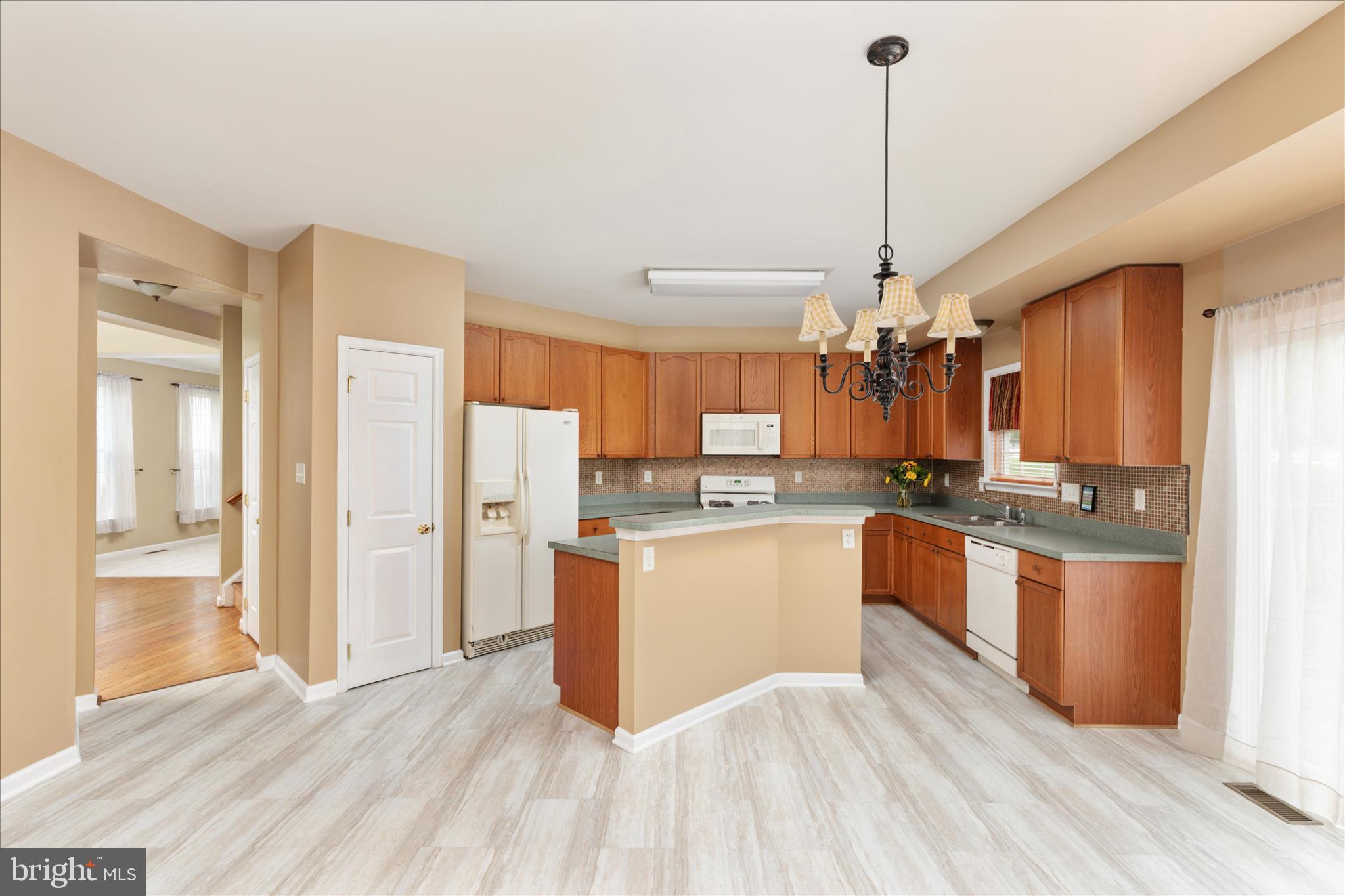42 Decatur Drive Bunker Hill, WV 25413 - Photo 25 of 81 a kitchen with stainless steel appliances granite countertop a refrigerator a sink dishwasher a oven and a dining table with wooden floor