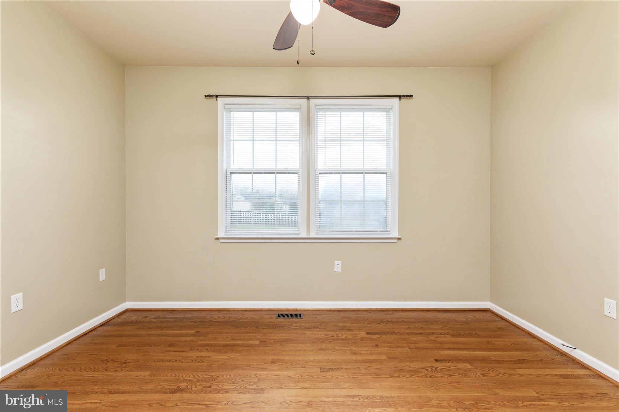 42 Decatur Drive Bunker Hill, WV 25413 - Photo 28 of 81 a view of an empty room with wooden floor and a window