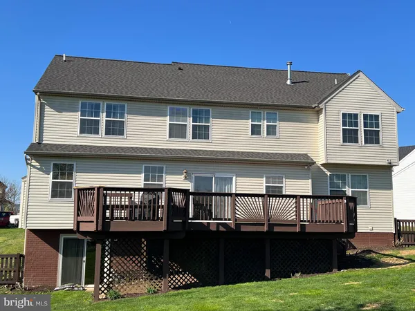 a view of a green field with trees in the background