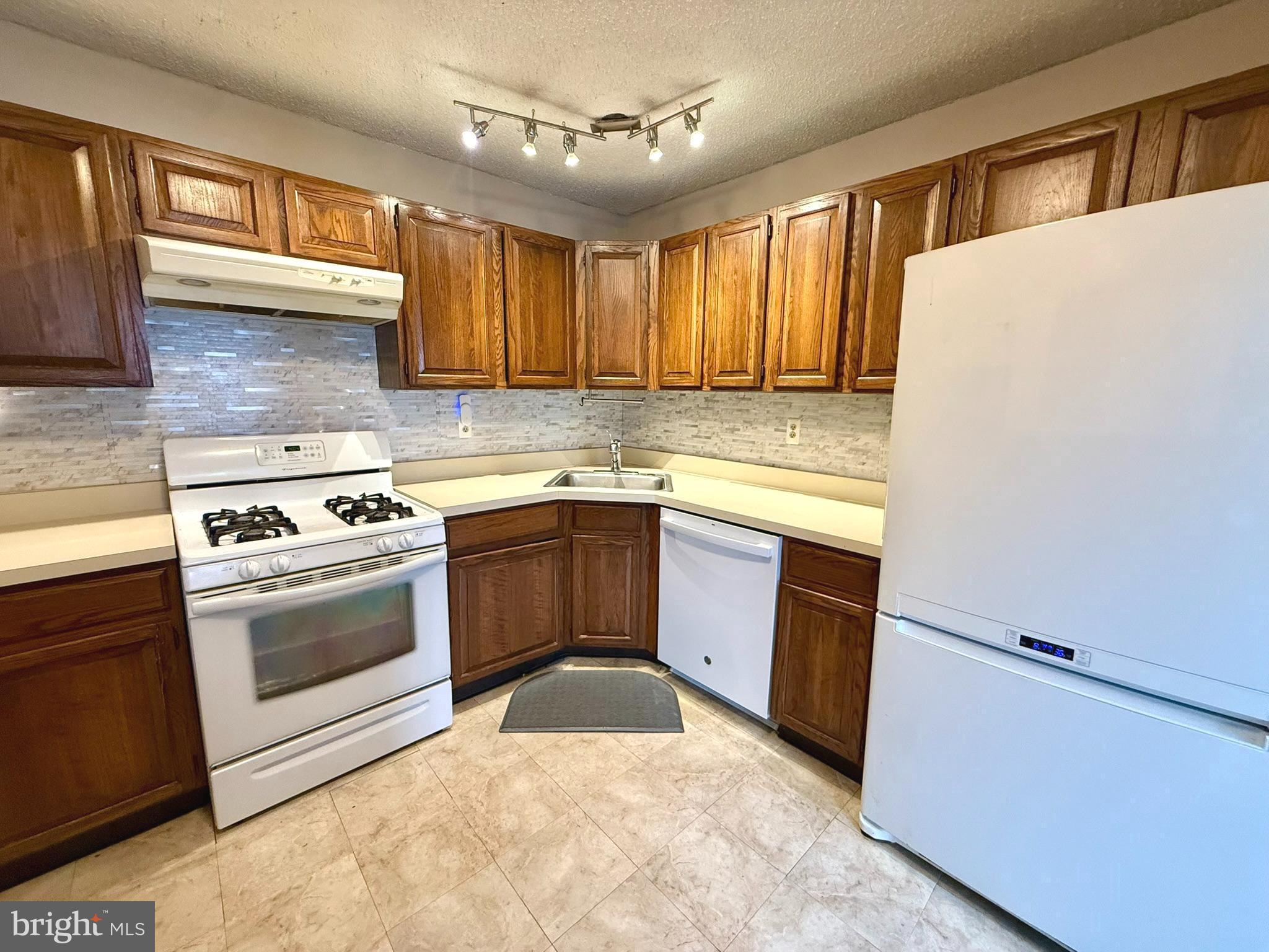 12 Juniper Way Hamilton, NJ 08619 - Photo 7 of 18 a kitchen with a stove sink and a refrigerator