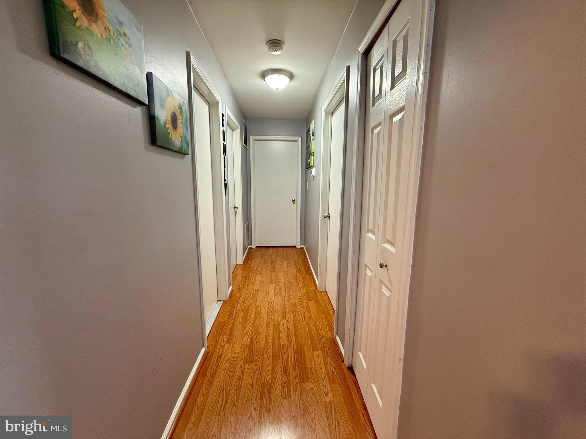 12 Juniper Way Hamilton, NJ 08619 - Photo 9 of 18 a view of a hallway with wooden floor and staircase