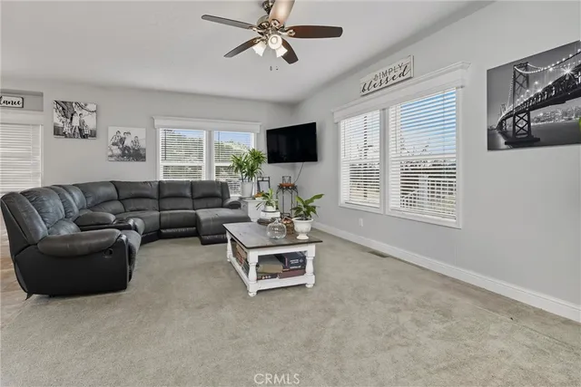 a living room with furniture window and a flat screen tv