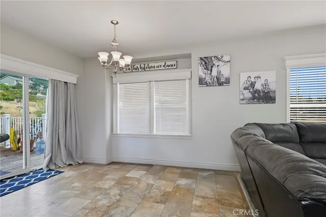 a living room with furniture window and wall painting