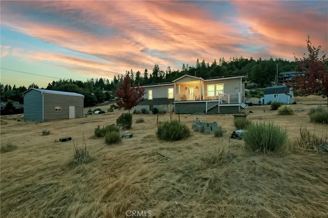 a backyard of a house with a yard and outdoor seating