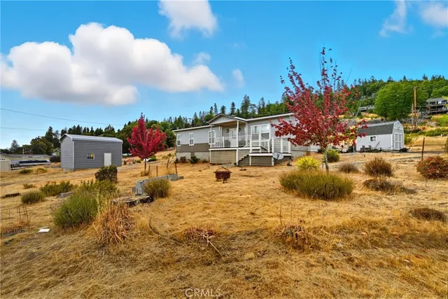 a view of a house with a yard and sitting area