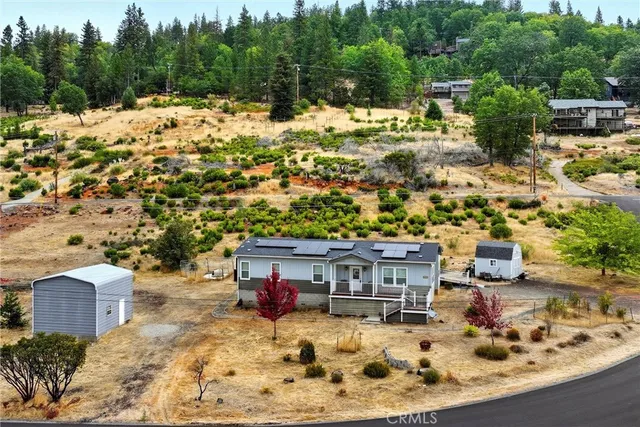 a view of a house with a yard covered in snow