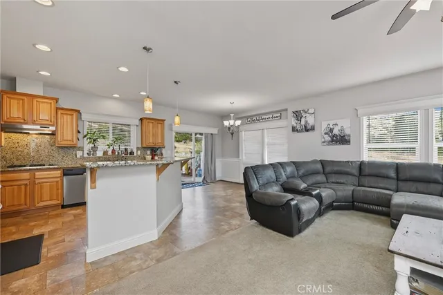 a living room with kitchen island furniture and kitchen view