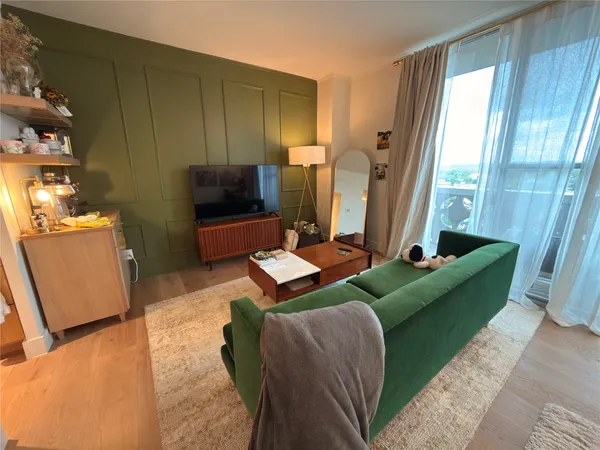 a bedroom with bed a window and a chandelier