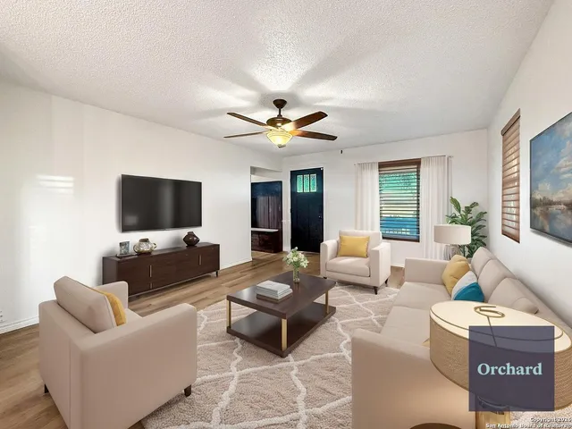 a living room with furniture and a flat screen tv