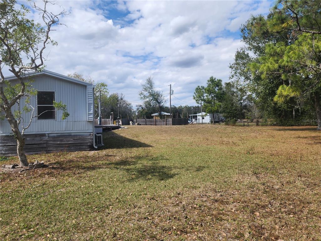 3114 Holly Hill Cutoff Road Davenport, FL 33837 - Photo 11 of 12 a view of a yard with wooden fence