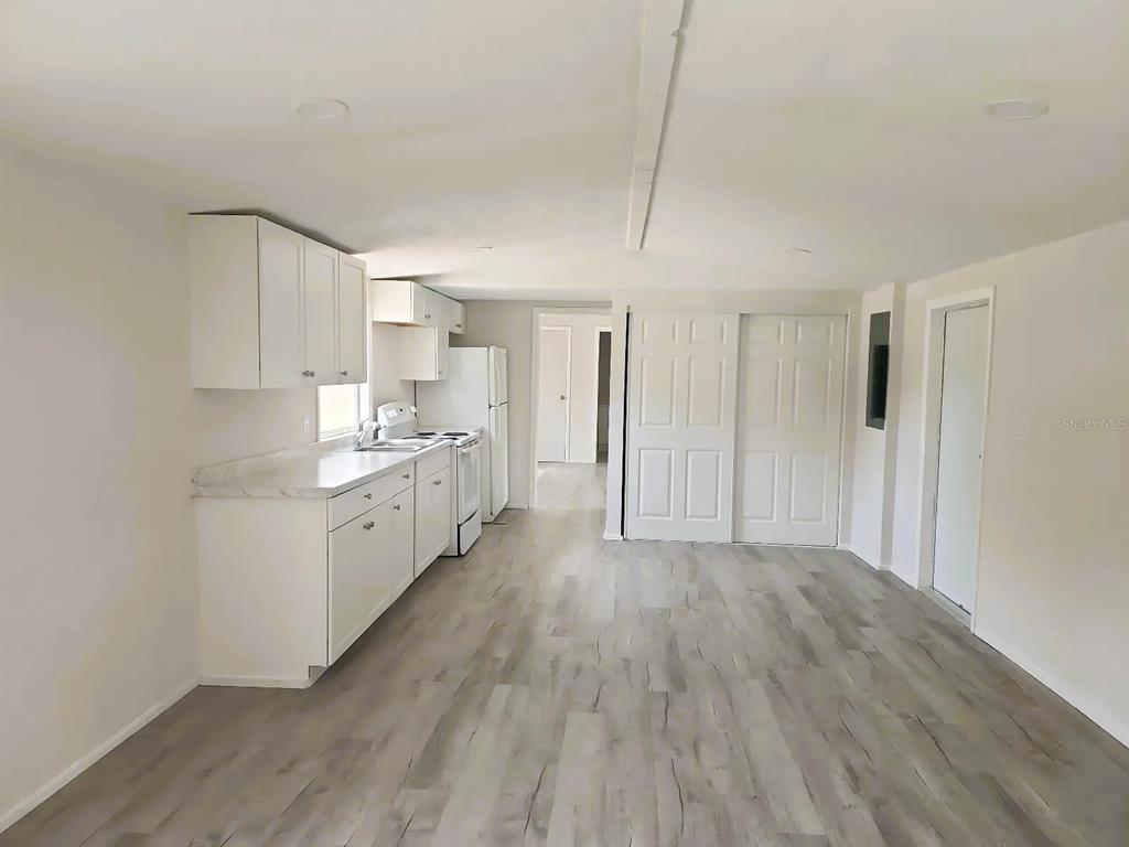3114 Holly Hill Cutoff Road Davenport, FL 33837 - Photo 4 of 12 a view of a kitchen with wooden floor