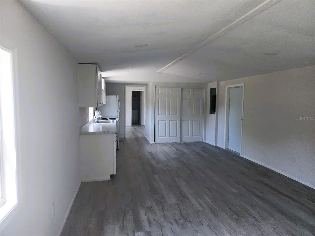 3114 Holly Hill Cutoff Road Davenport, FL 33837 - Photo 5 of 12 a view of empty room with wooden floor