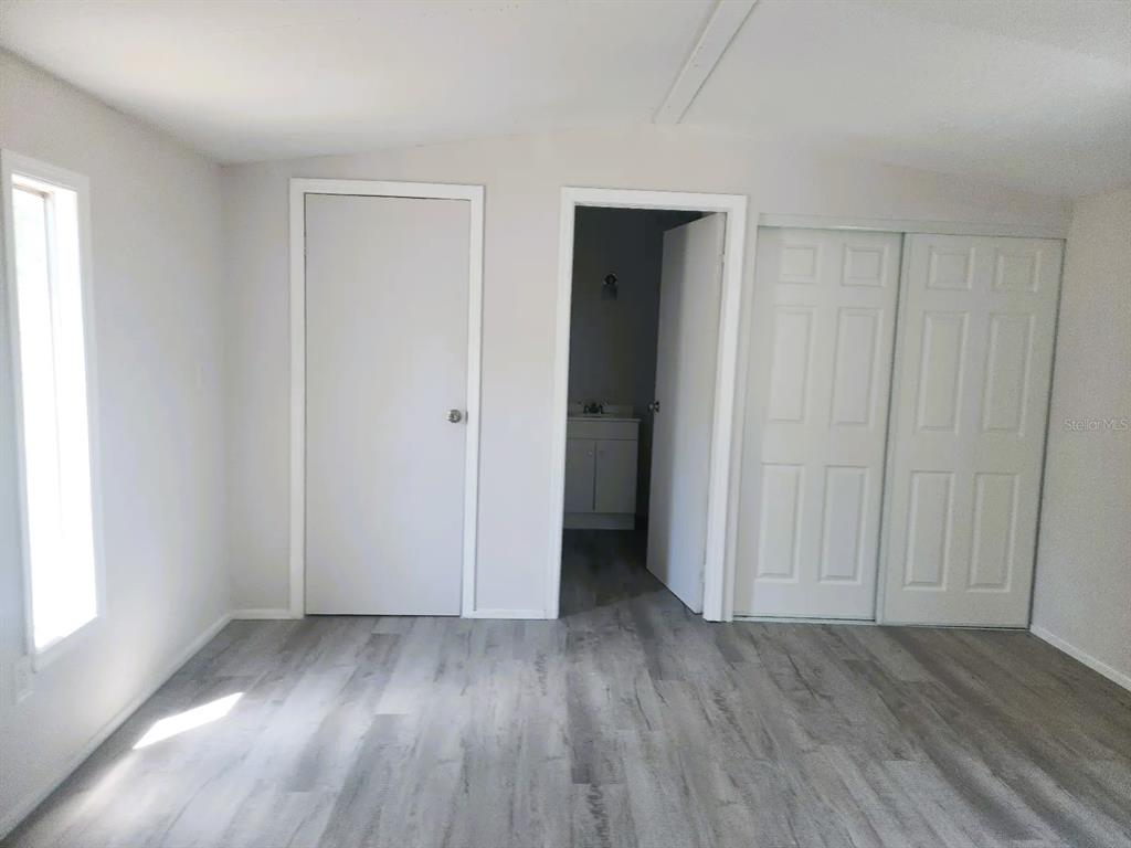 3114 Holly Hill Cutoff Road Davenport, FL 33837 - Photo 7 of 12 an empty room with closet and a window