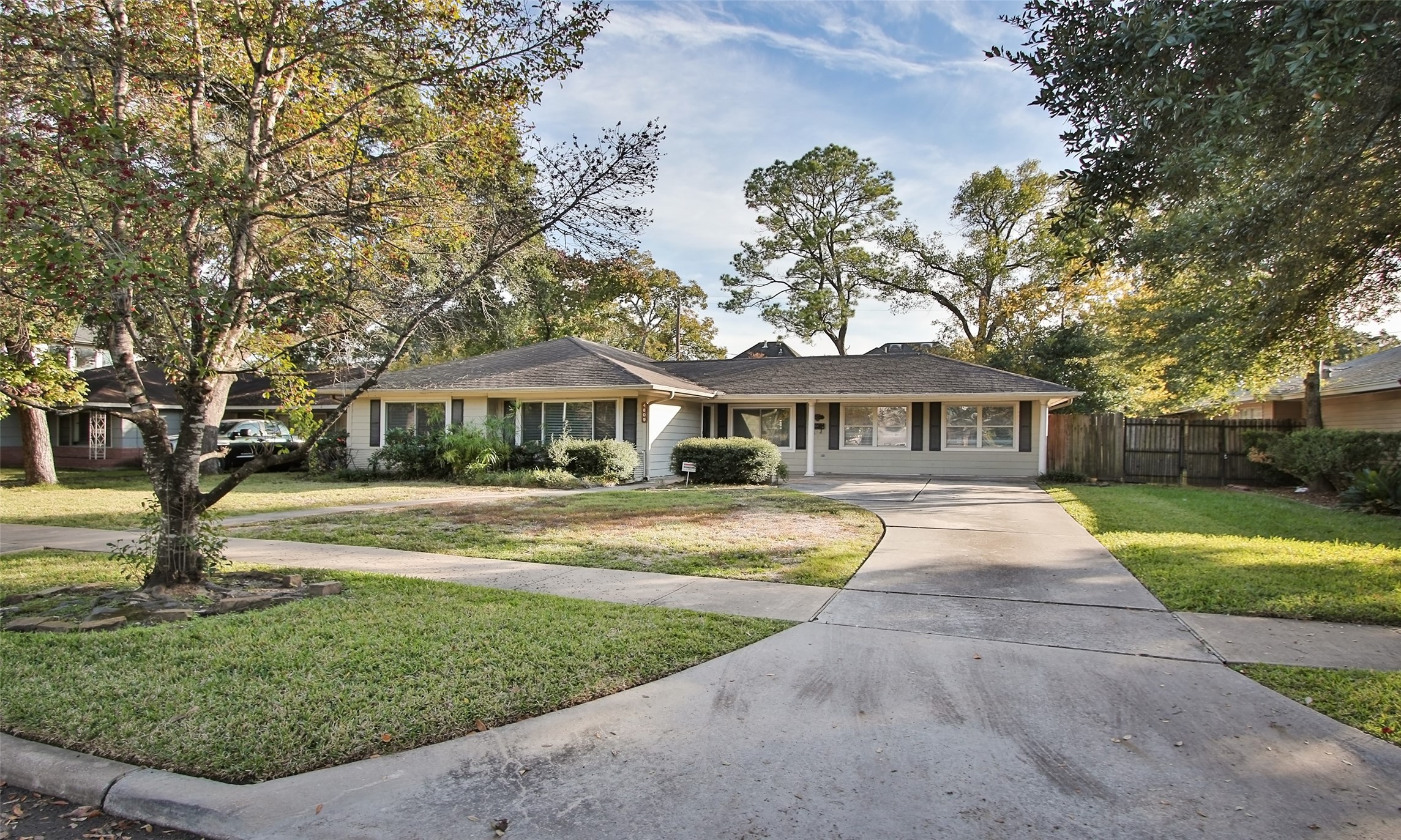 4809 Saxon Street Bellaire, TX 77401 - Photo 2 of 34 a front view of a house with a garden