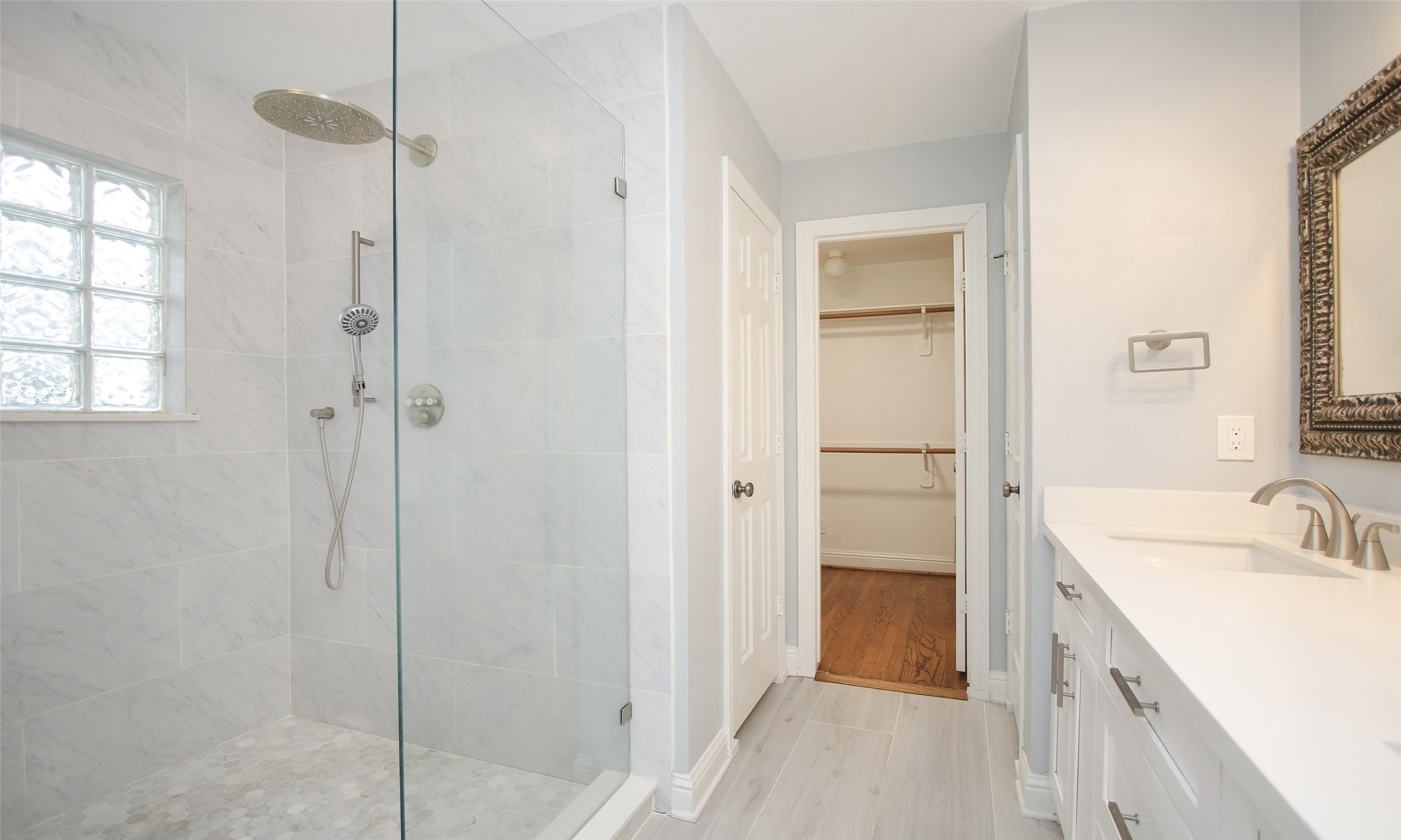 4809 Saxon Street Bellaire, TX 77401 - Photo 25 of 34 a bathroom with a double vanity sink a mirror and a shower