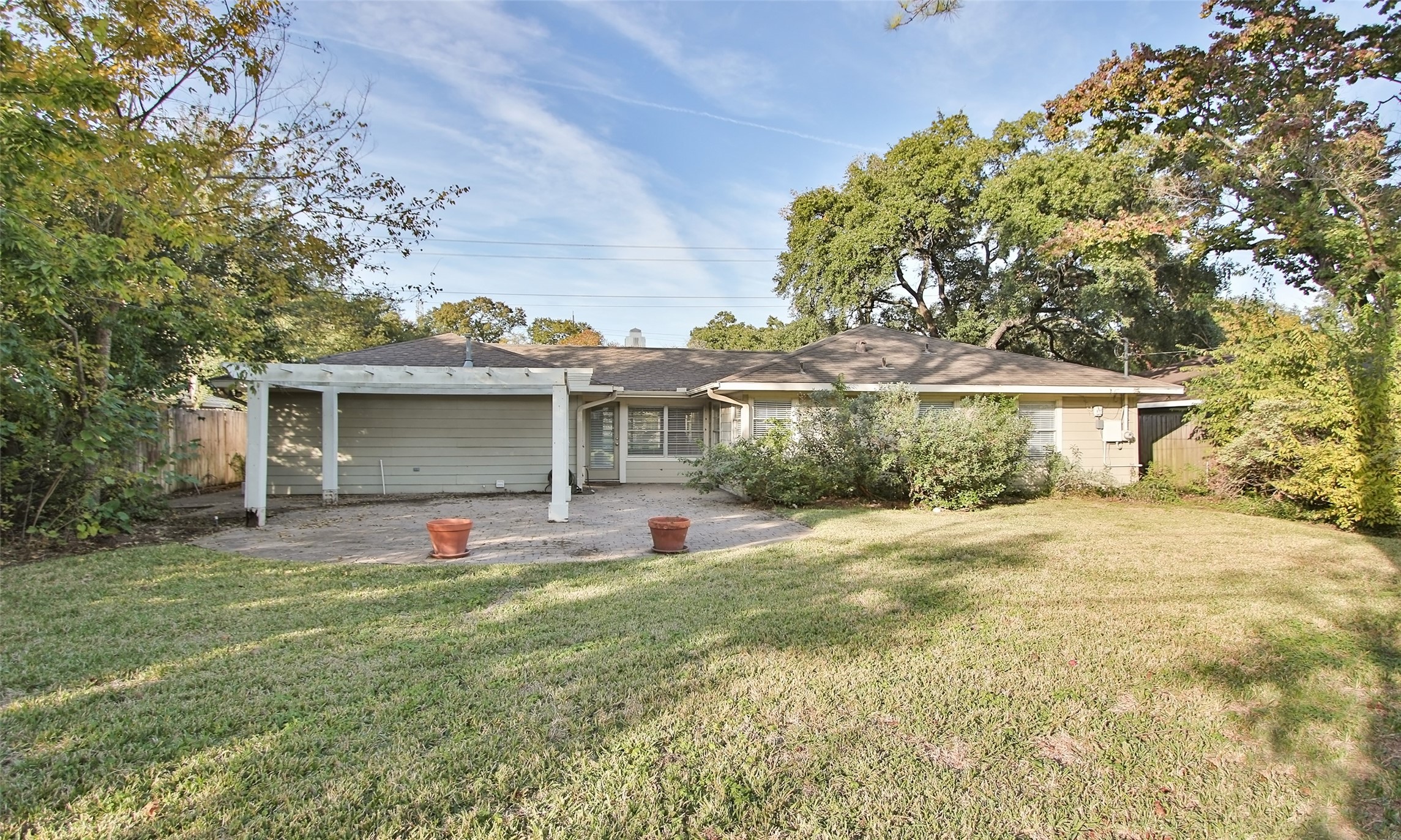 4809 Saxon Street Bellaire, TX 77401 - Photo 32 of 34 a front view of a house with a yard and garage