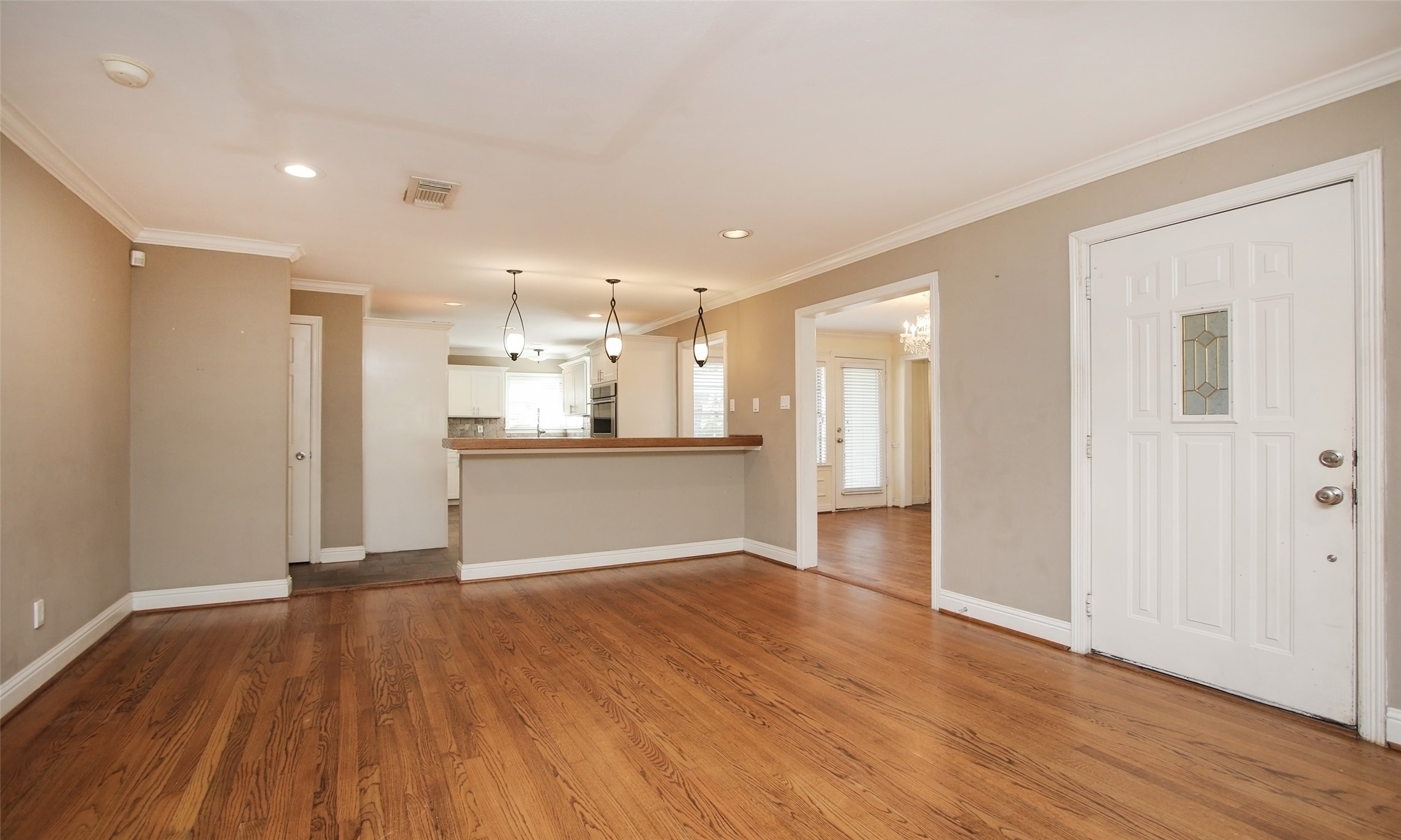 4809 Saxon Street Bellaire, TX 77401 - Photo 9 of 34 a view of a kitchen with a fridge and wooden floor