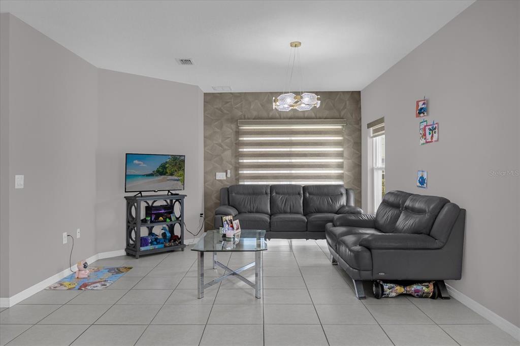 3470 Beau Road Kissimmee, FL 34746 - Photo 7 of 40 a living room with furniture and a window