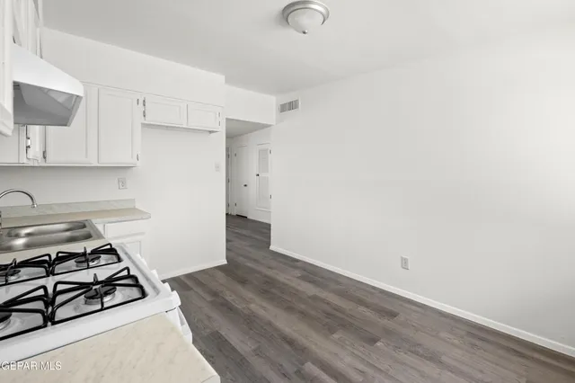 a kitchen with a stove and a refrigerator