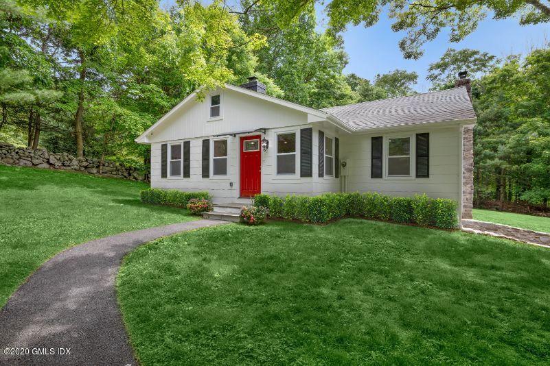 142 Old Mill Road Greenwich, CT 06831 - Photo 1 of 23 a front view of house with yard and green space