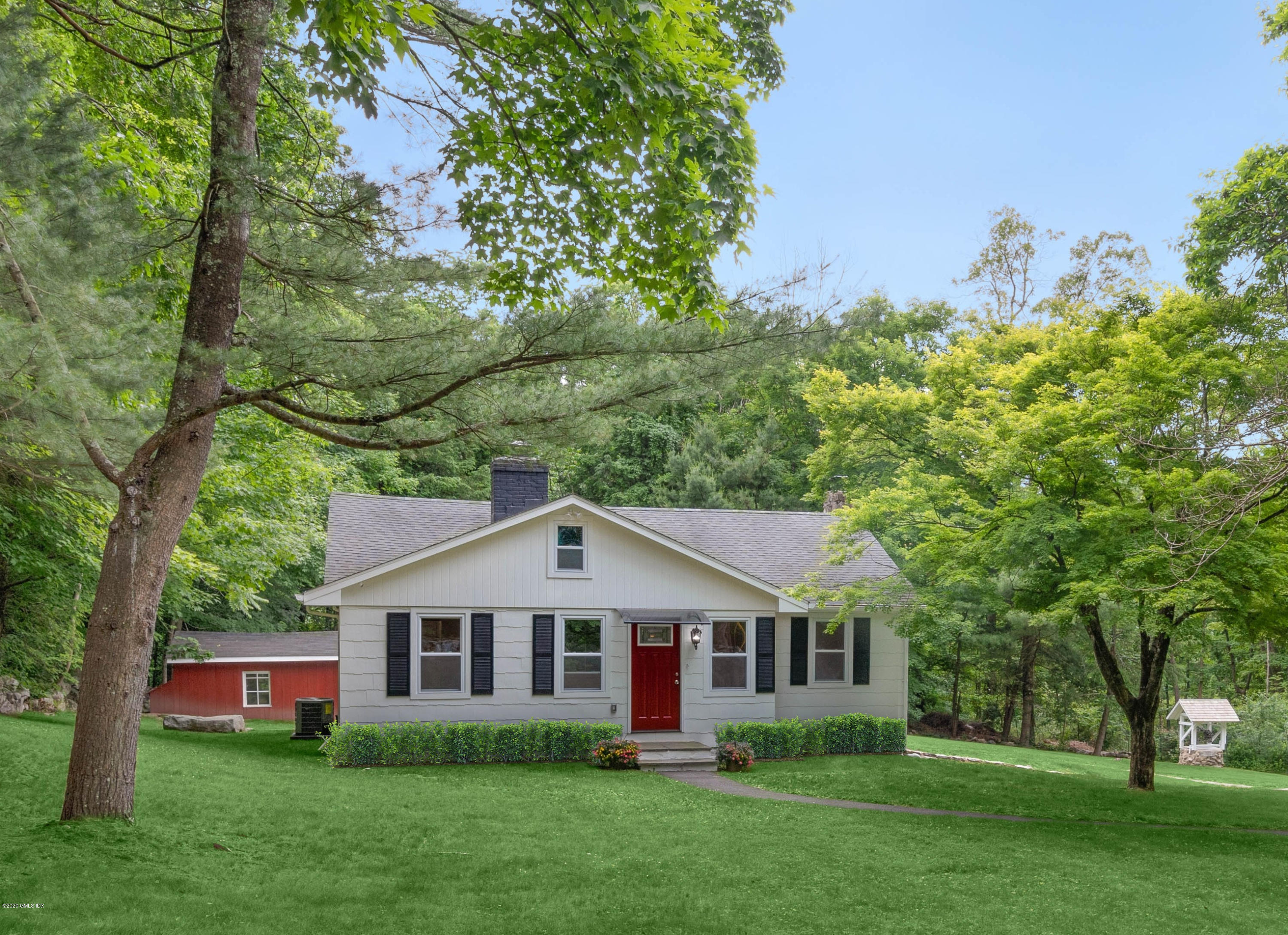 142 Old Mill Road Greenwich, CT 06831 - Photo 2 of 23 front view of a house with a yard