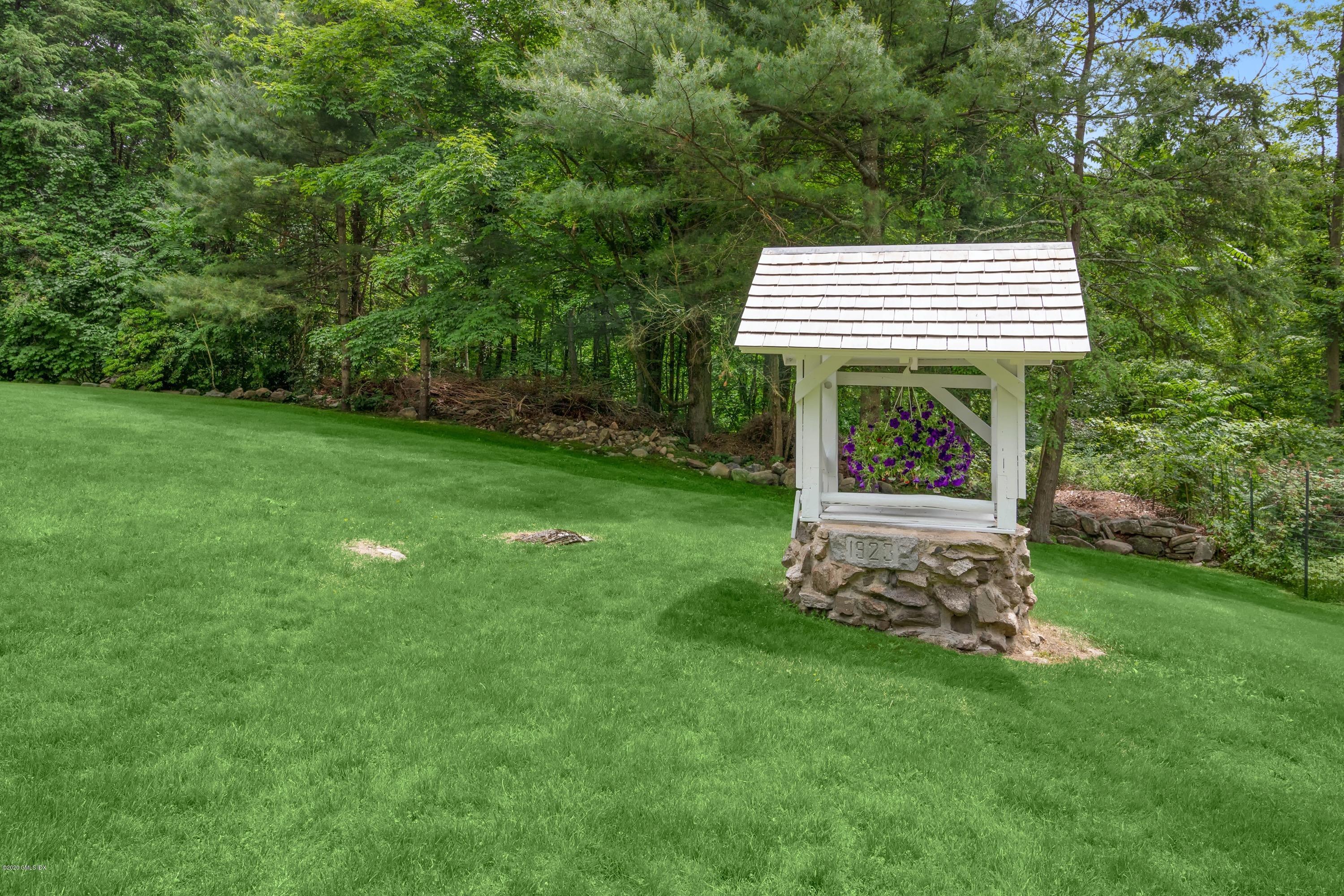 142 Old Mill Road Greenwich, CT 06831 - Photo 22 of 23 a view of a house with a backyard