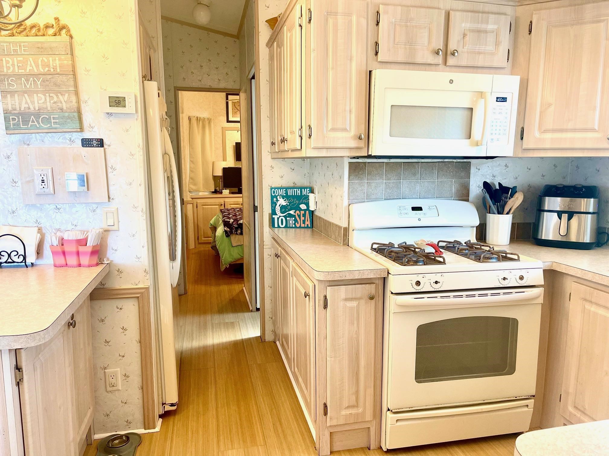 4100 Rte 9 South, Unit 56 Rio Grande, NJ 08242 - Photo 11 of 30 a kitchen with a stove a sink and a refrigerator