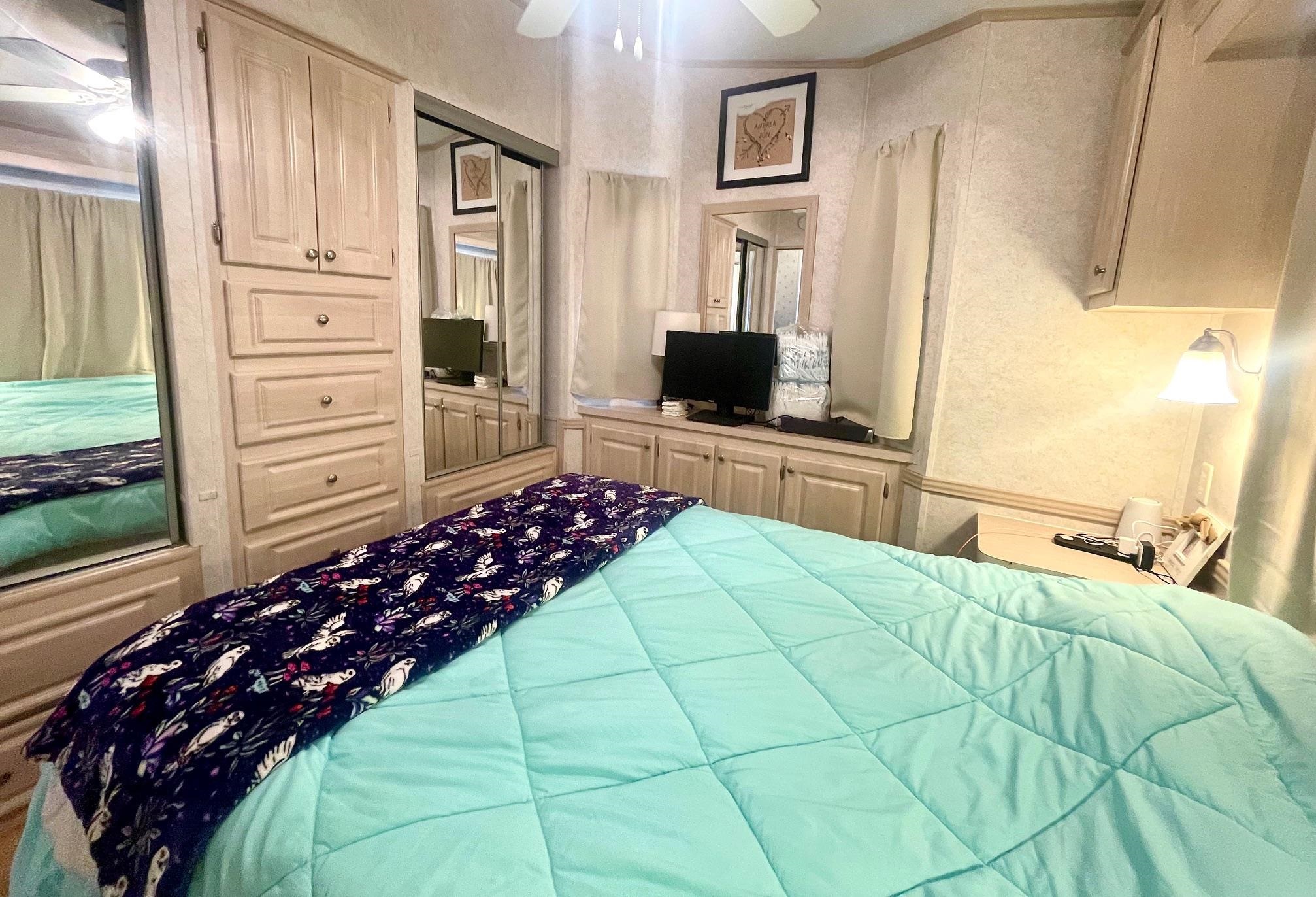 4100 Rte 9 South, Unit 56 Rio Grande, NJ 08242 - Photo 14 of 30 a bedroom with a bed mirror on desk and a window