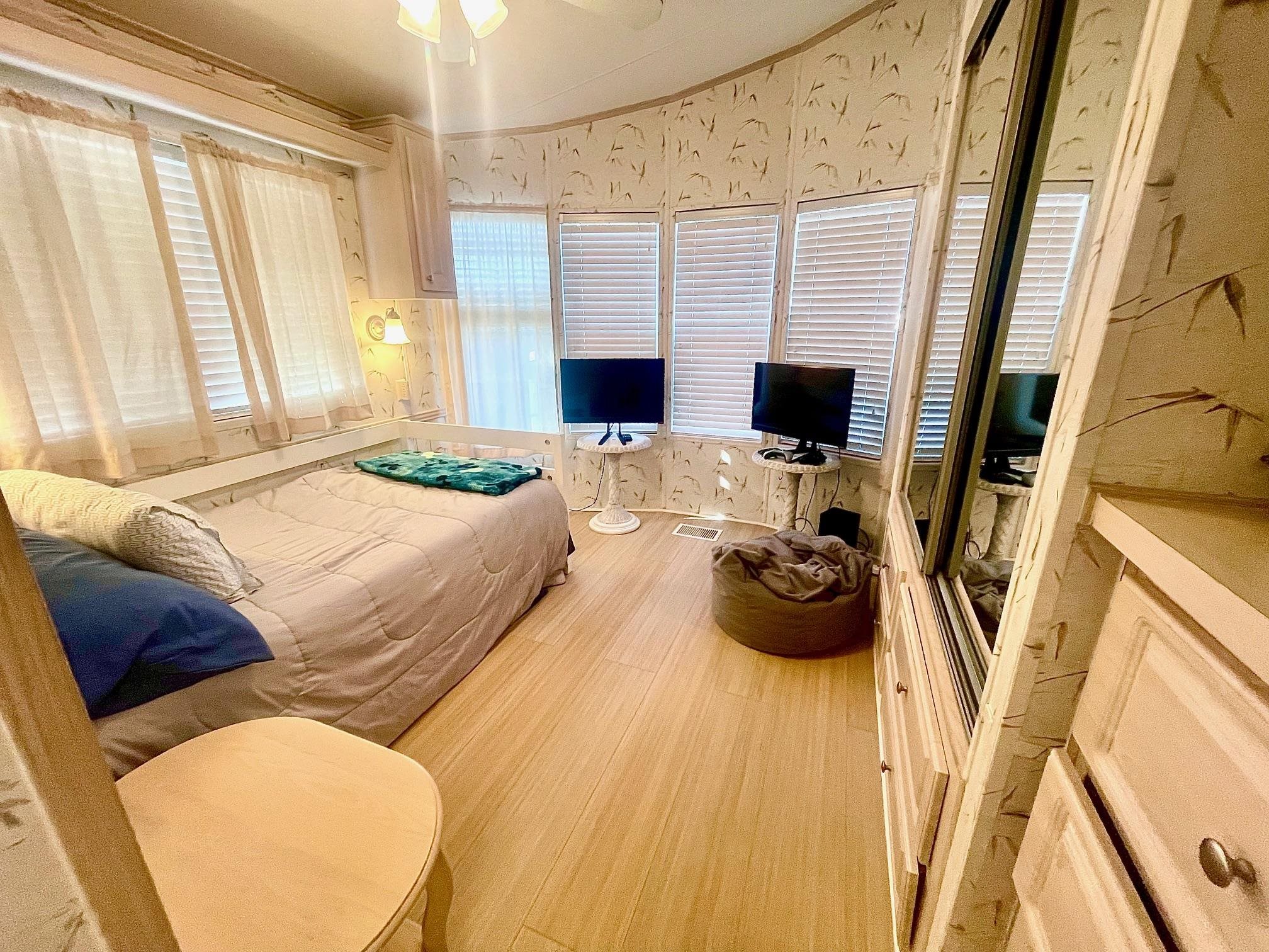4100 Rte 9 South, Unit 56 Rio Grande, NJ 08242 - Photo 15 of 30 a bedroom with a bed and a chandelier