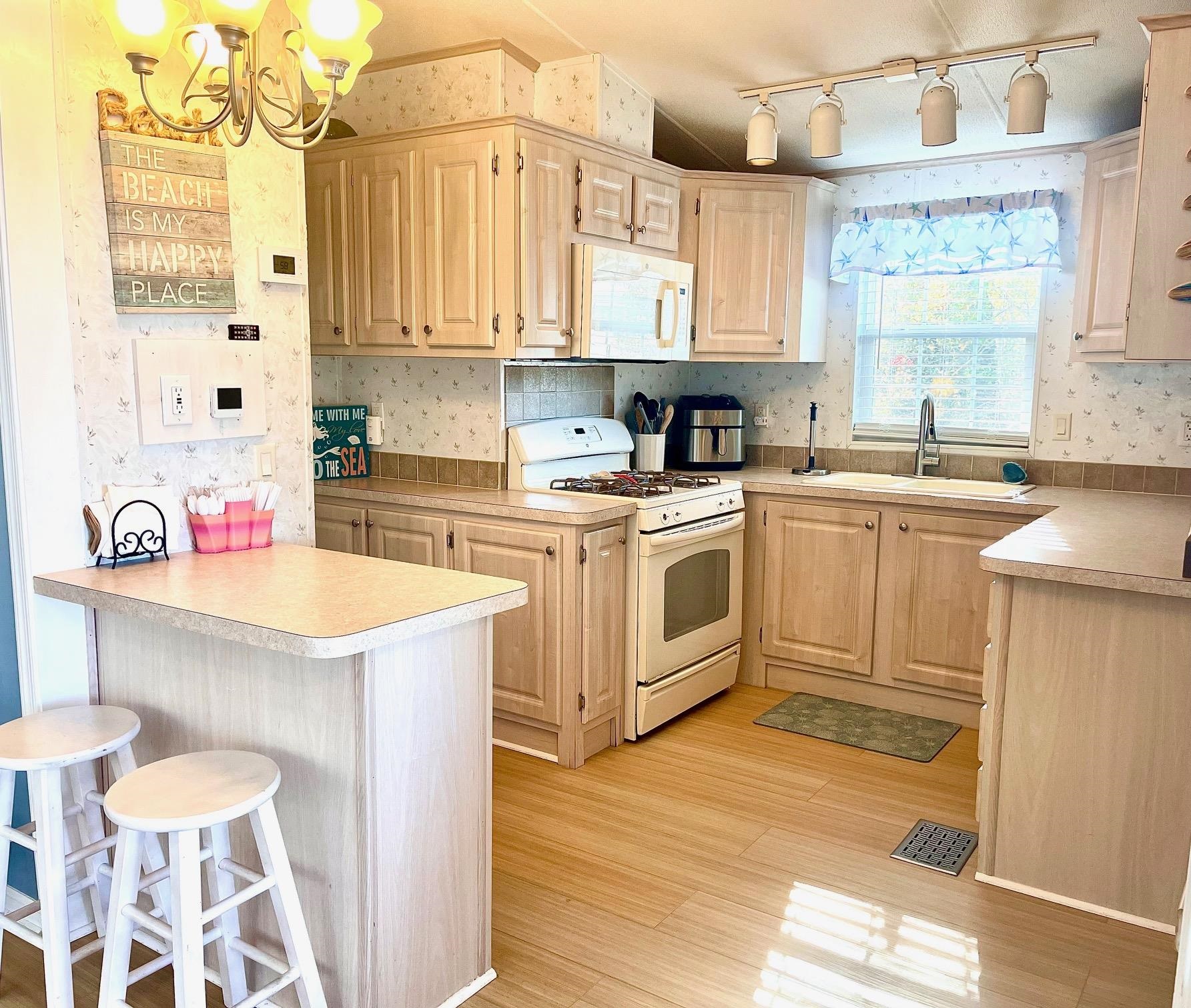 4100 Rte 9 South, Unit 56 Rio Grande, NJ 08242 - Photo 10 of 30 a kitchen with a sink stove and white cabinets