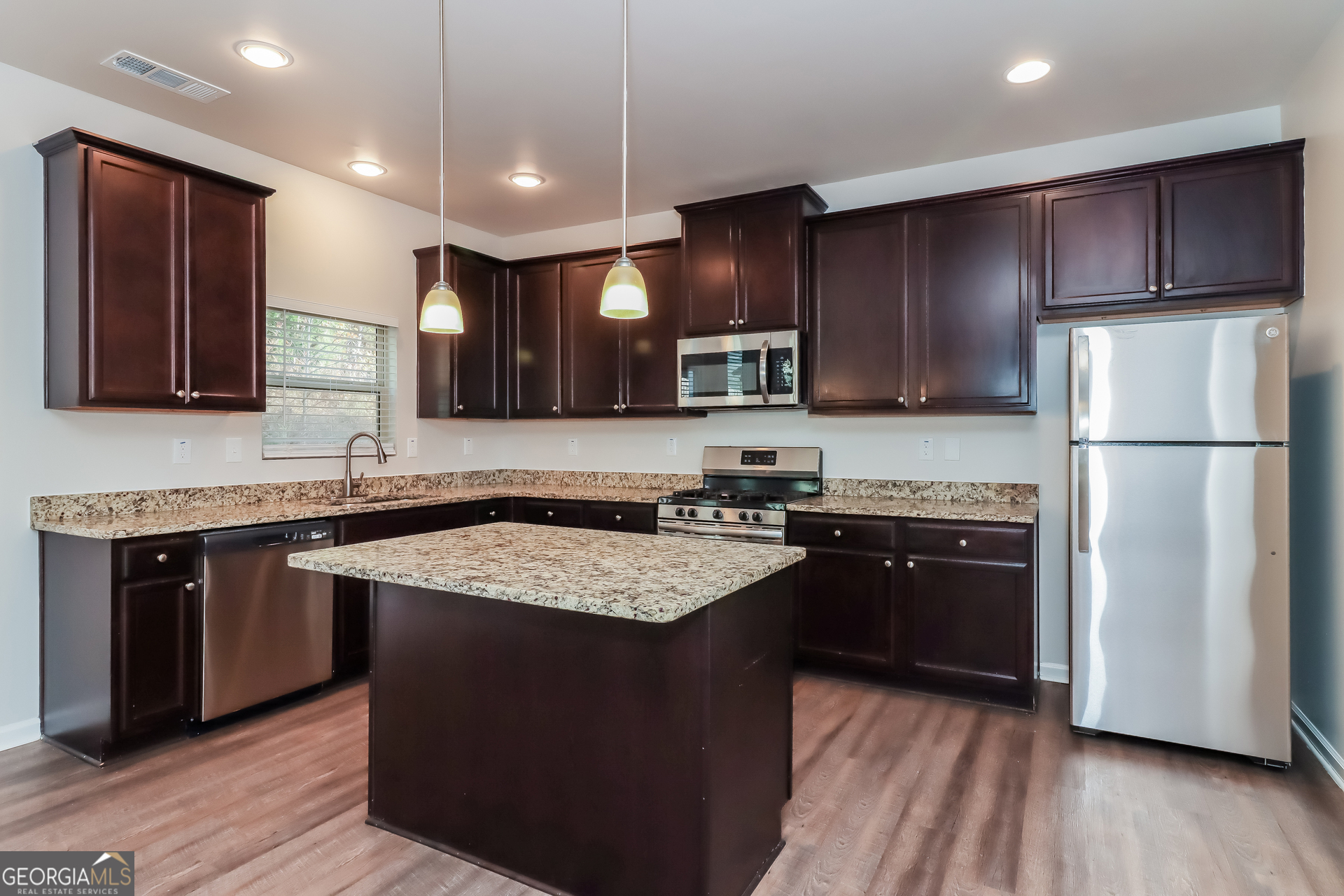194 Randy Way Dallas, GA 30132 - Photo 5 of 17 a kitchen with stainless steel appliances granite countertop a stove a sink dishwasher a refrigerator and a oven with wooden floor