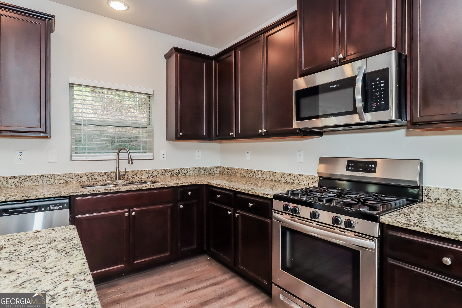 194 Randy Way Dallas, GA 30132 - Photo 6 of 17 a kitchen with granite countertop wooden cabinets and stainless steel appliances
