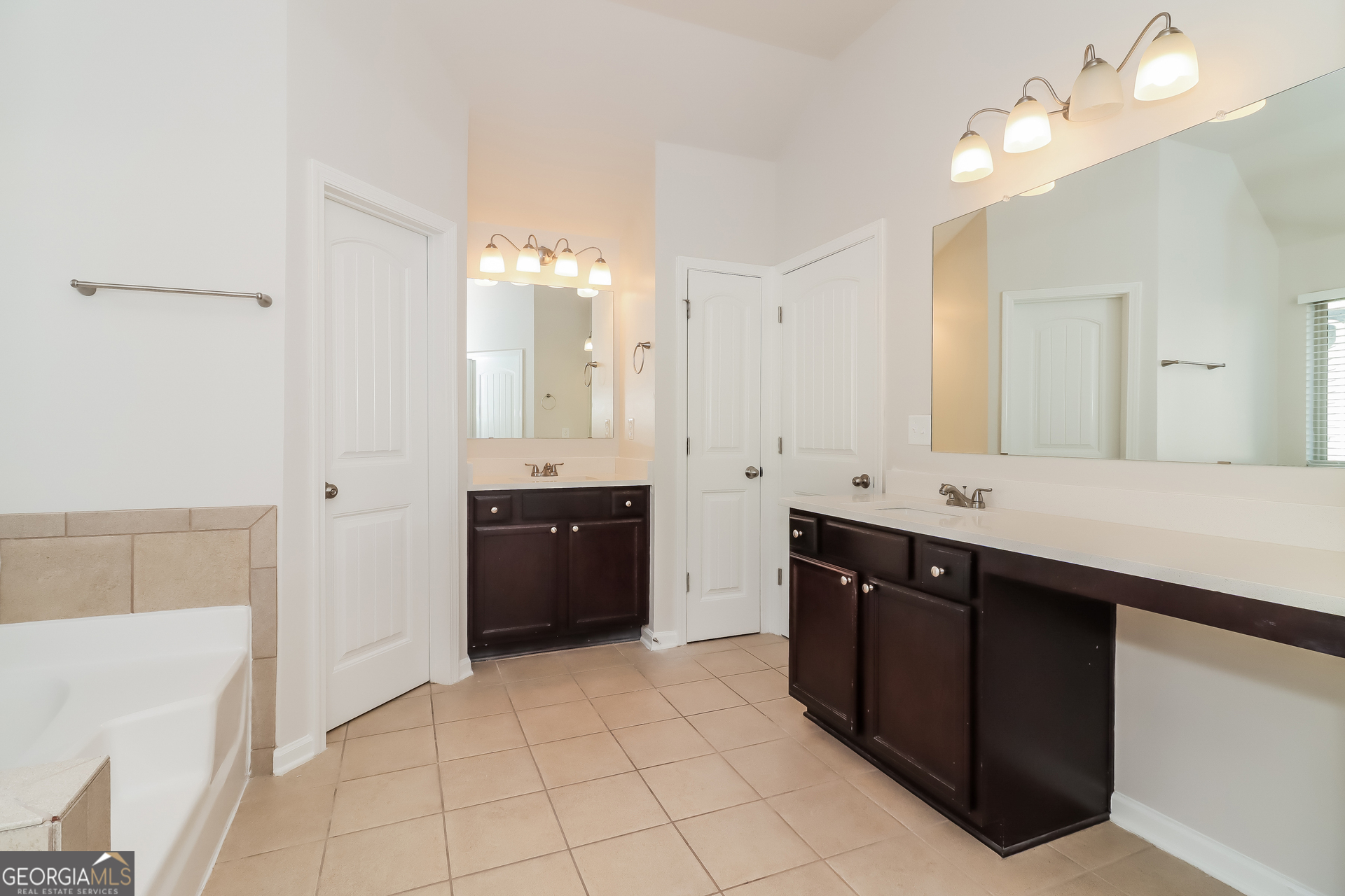 194 Randy Way Dallas, GA 30132 - Photo 9 of 17 a spacious bathroom with a double vanity sink a mirror and a bathtub