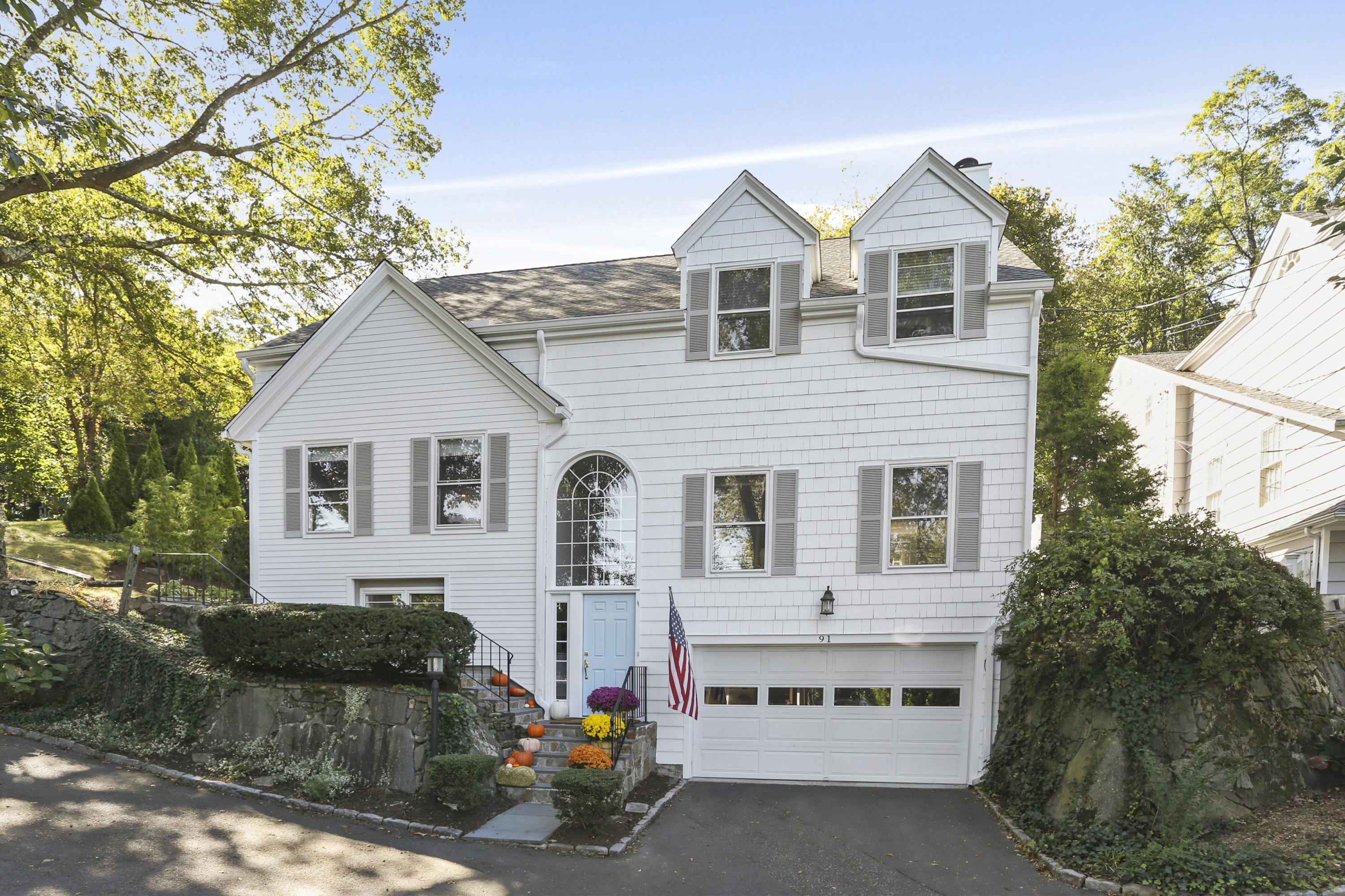 91 Gardiner Street Darien, CT 06820 - Photo 1 of 33 a front view of a house with a garden