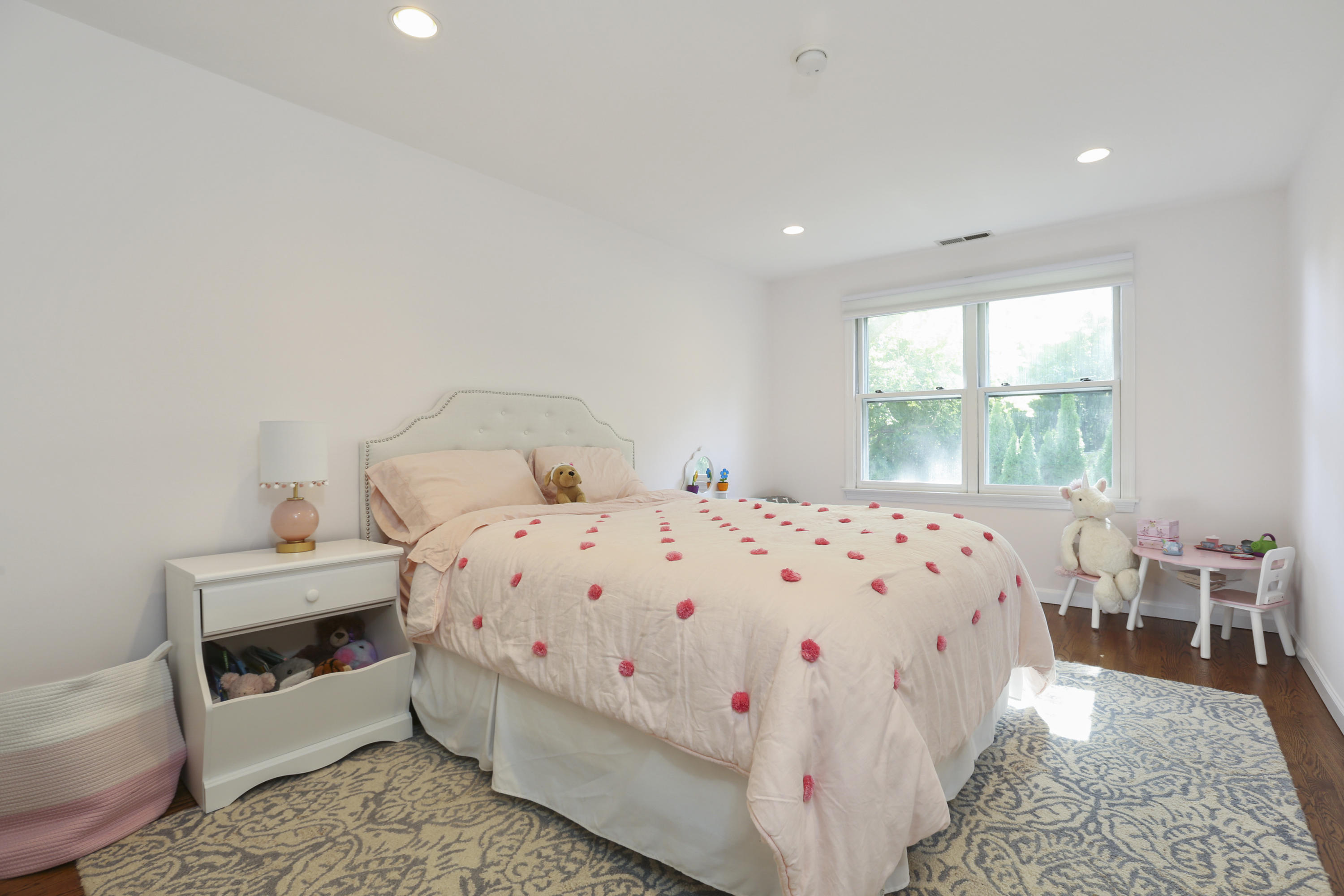 91 Gardiner Street Darien, CT 06820 - Photo 23 of 33 a bed sitting in a bedroom next to a window with chair