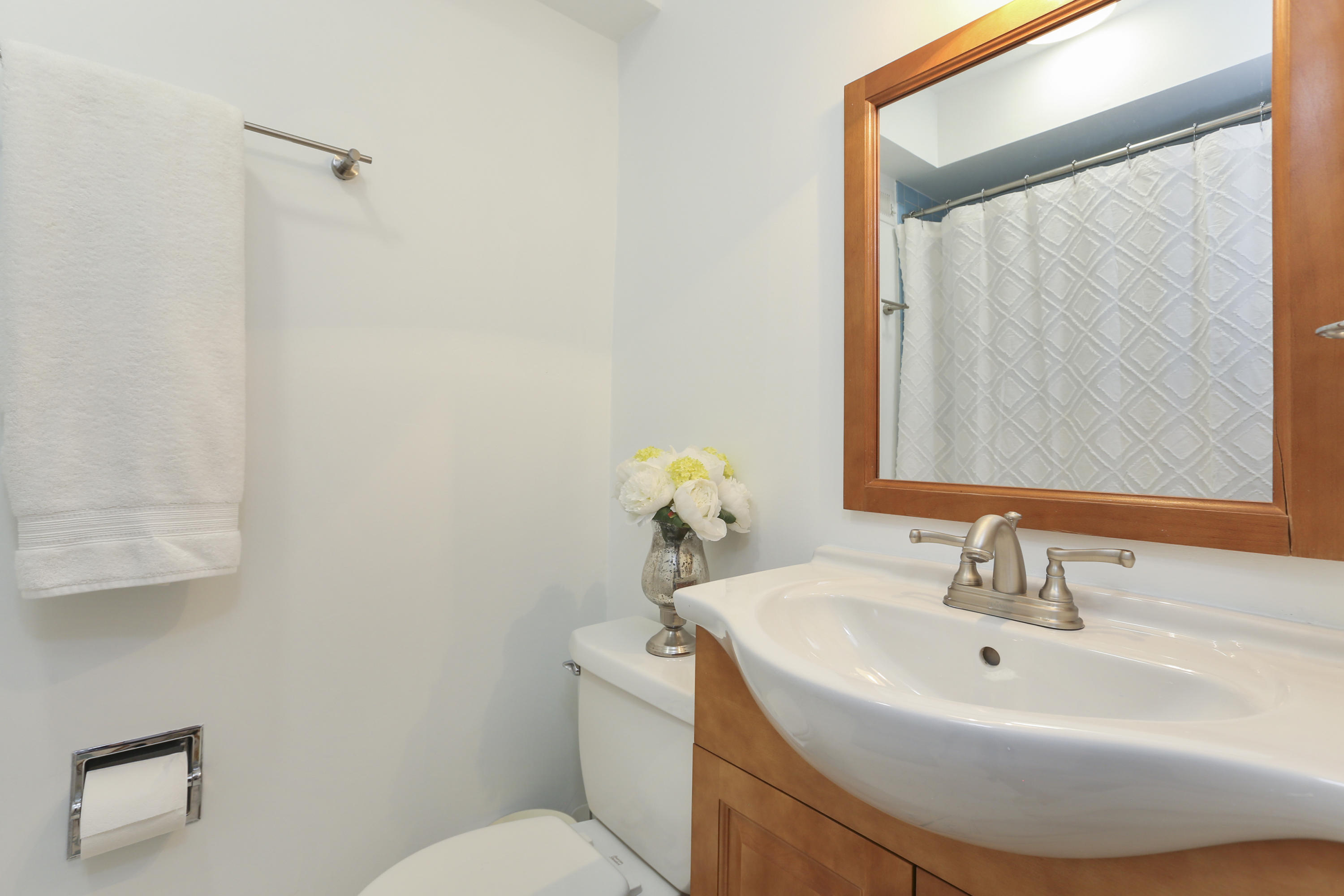 91 Gardiner Street Darien, CT 06820 - Photo 27 of 33 a bathroom with a sink a toilet and a mirror