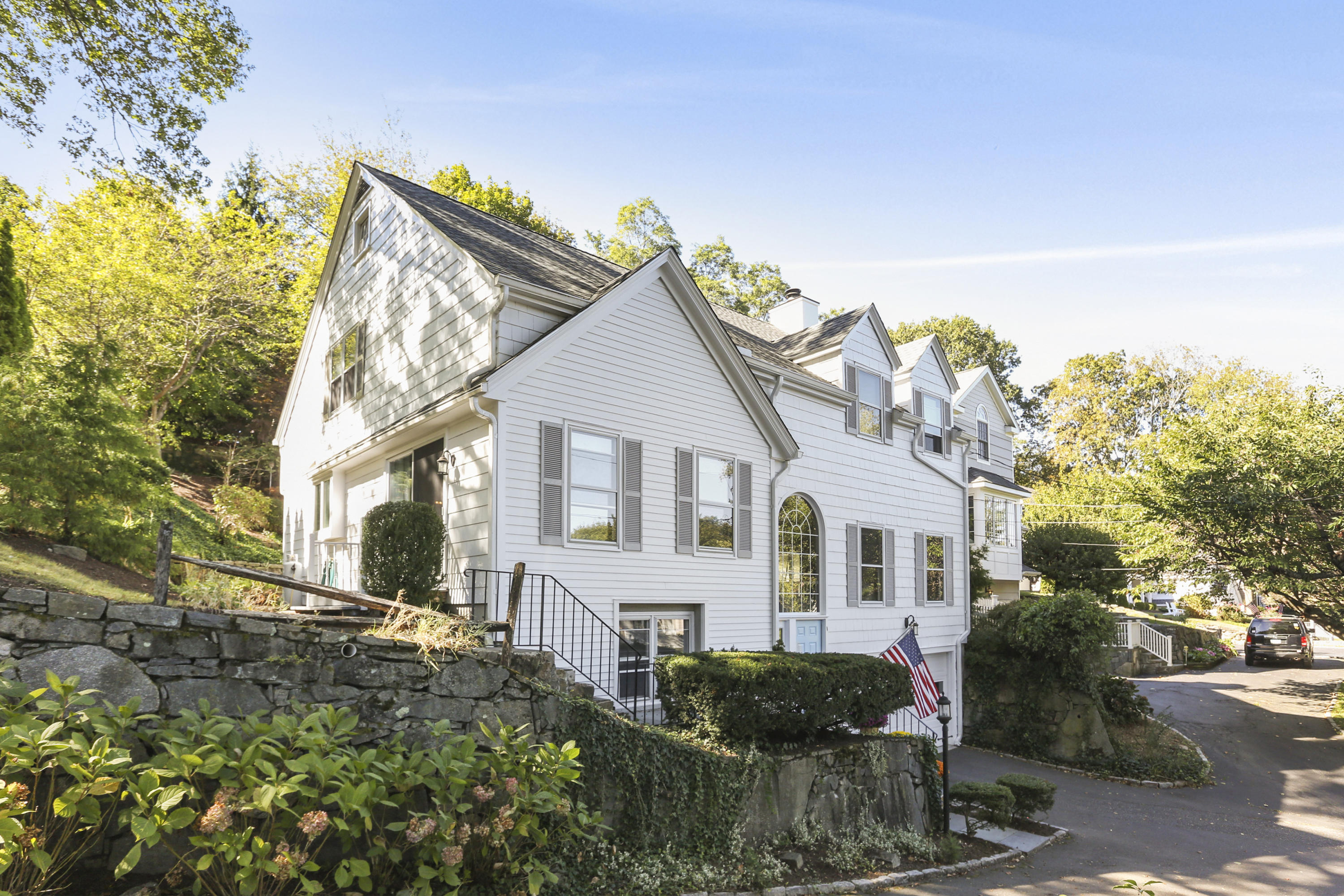 91 Gardiner Street Darien, CT 06820 - Photo 3 of 33 a view of a white house next to a yard with large trees