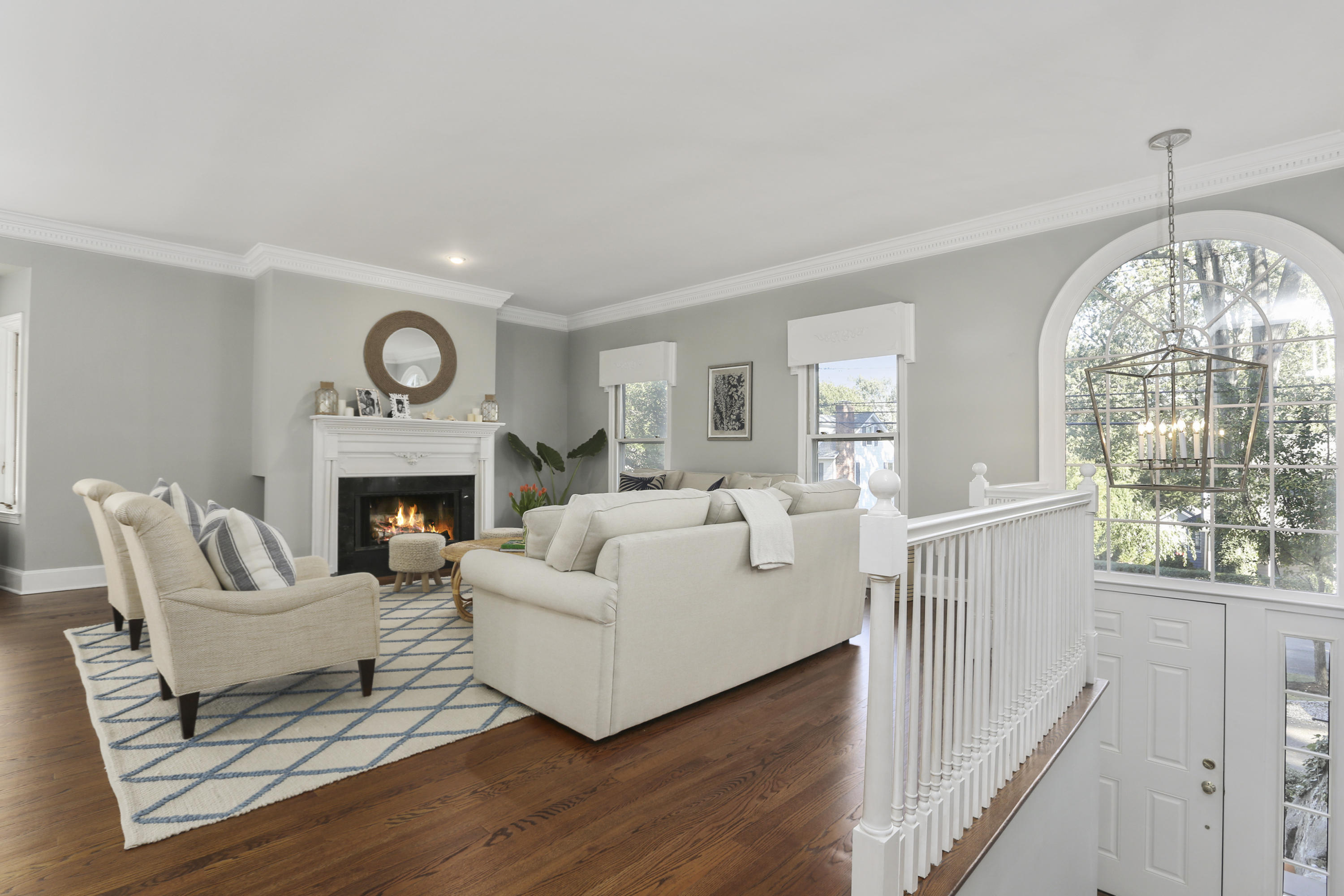 91 Gardiner Street Darien, CT 06820 - Photo 7 of 33 a living room with furniture a fireplace and a large window